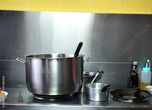 Stainless kitchenware with stove and assorted pots in breakfast shop