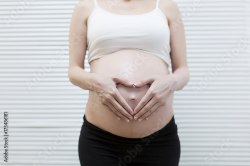 Free Download Picture of pregnant woman holding heart sign to one side - GFXLoad