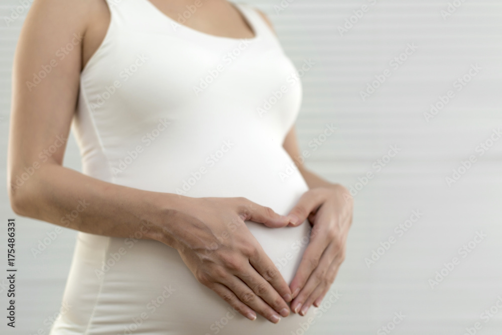 custom made wallpaper toronto digitalPicture of pregnant woman holding heart sign to one side