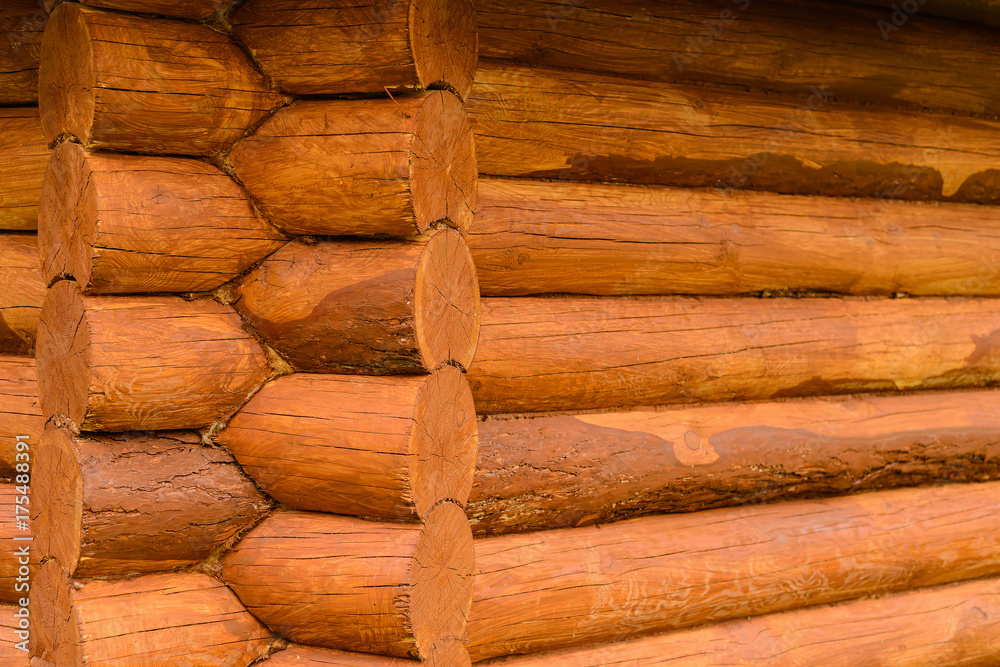 Closeup view of corner of wooden house made of natural logs Closeup view of corner of wooden house made of natural logs