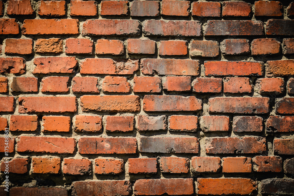 Naklejka premium red brick wall texture grunge background with vignetted corners