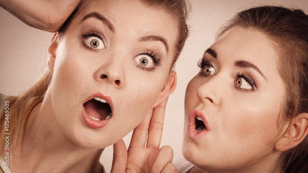 Two women telling gossip Two women telling gossip