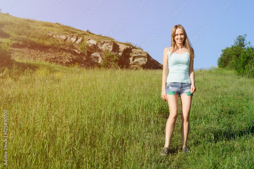 beautiful happy girl dressed on country style smiling and posing on grass meadow beautiful happy girl dressed on country style smiling and posing on grass meadow