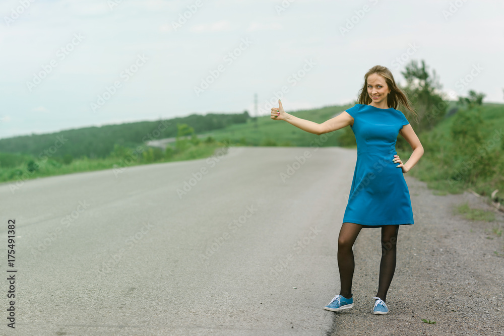 Pretty young girl catches a ride on the highway