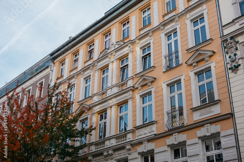 orange facaded house with white pieces