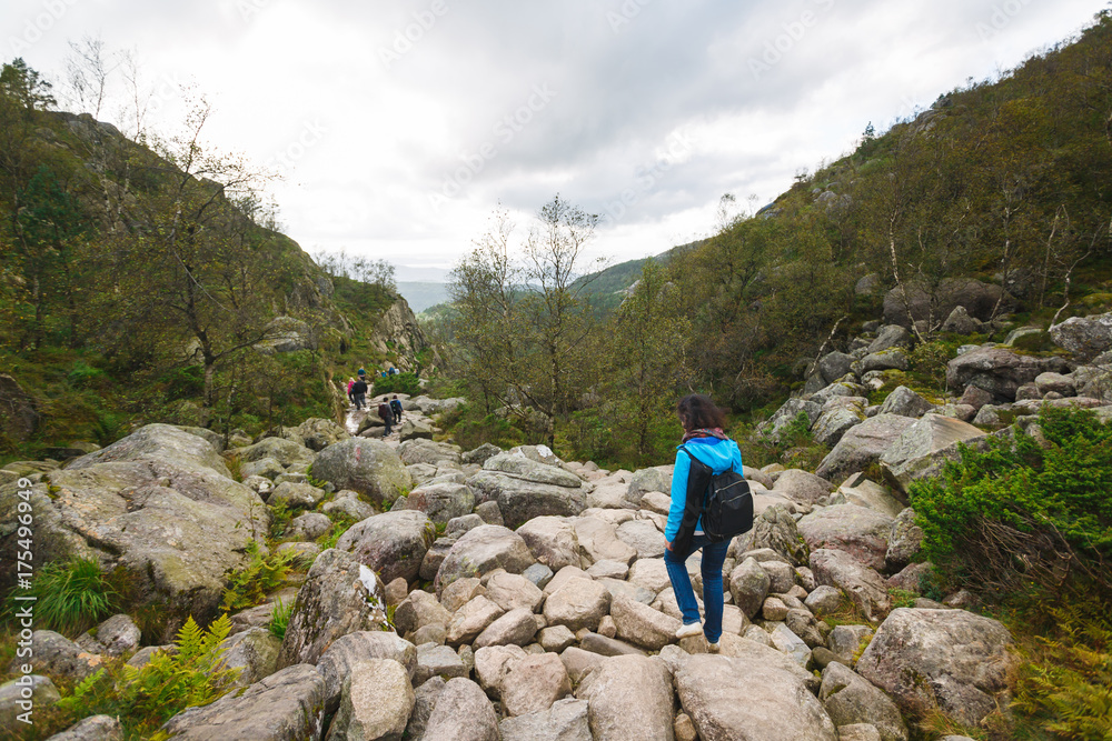 Woman is hiking in the mountains in summertime Woman is hiking in the mountains in summertime