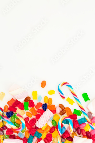 Assorted colorful bright candies on white background. Flat lay, top view