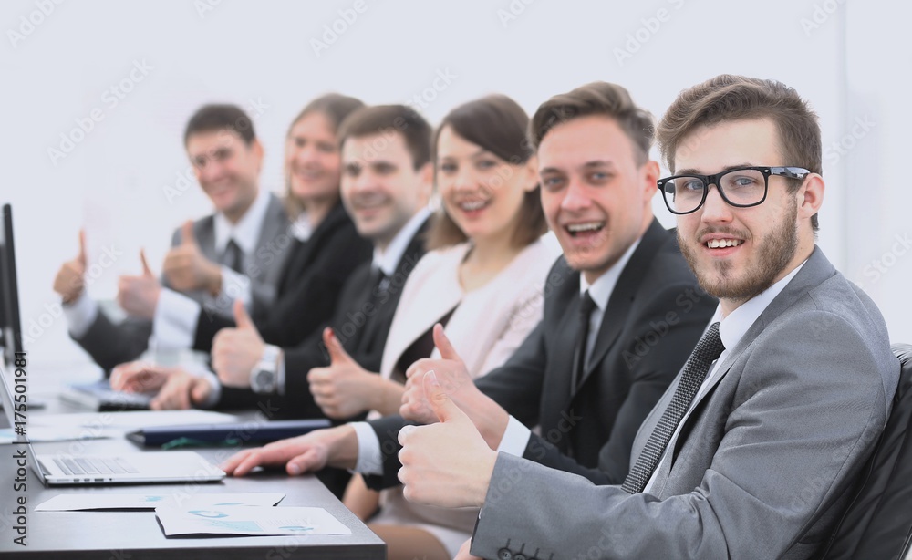 business team with thumbs up while sitting at his Desk business team with thumbs up while sitting at his Desk
