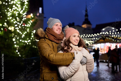 happy couple hugging at christmas tree