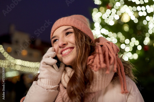 happy woman calling on smartphone at christmas