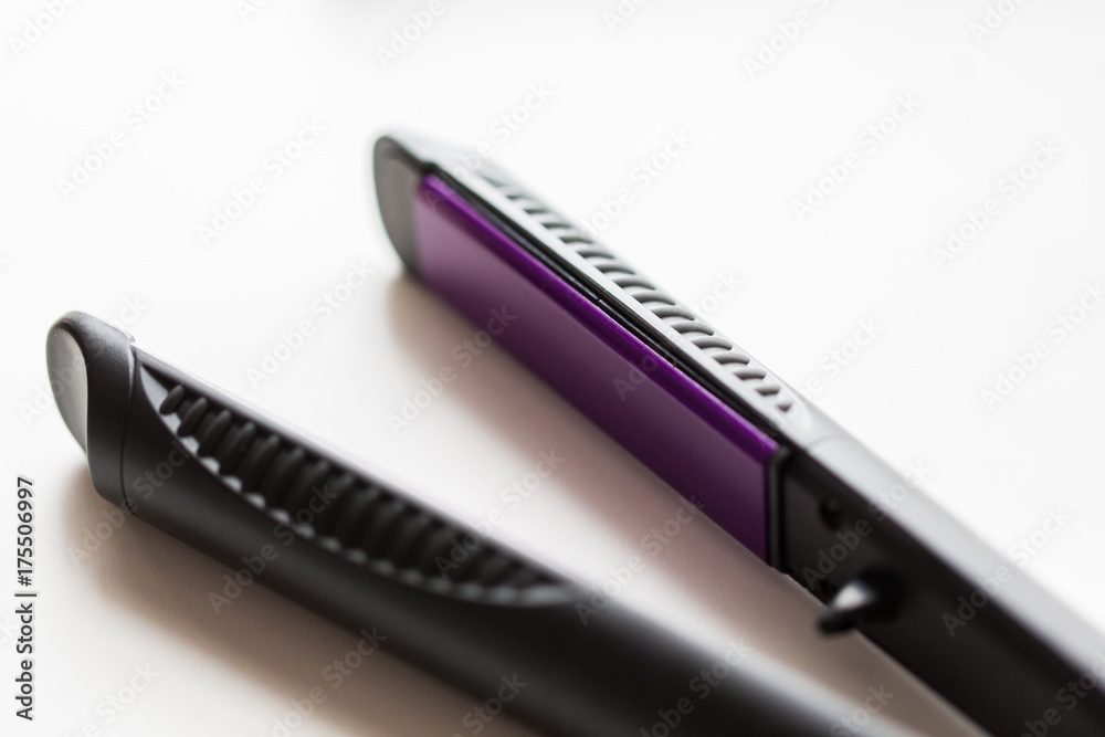 close up of flat hair straightening iron close up of flat hair straightening iron