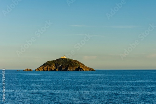 Small island in Mediterranean sea with small fort near Tuscany coast