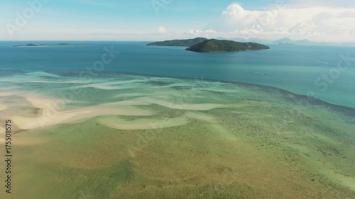 Top view of river, surrounded by trees, and small island wirh green trees. Summer river Ob in Siberia, view from the top. Flying above calm water, river and nature landscape. Areial view. photo