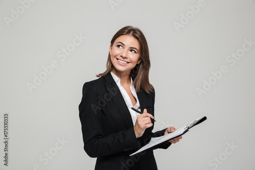 Portrait of a smiling young businesswoman in suit