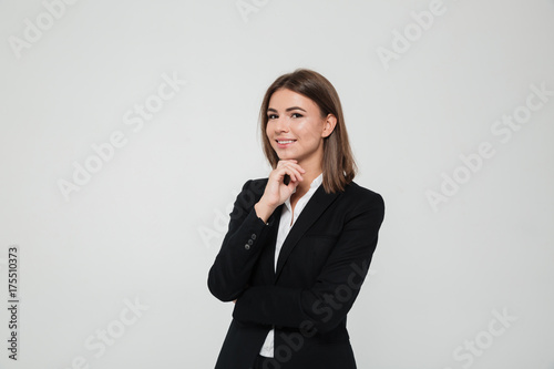 Portrait of young brown-haired businesswoman in suit