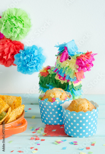 Nachos with guacamole and beer with colorful flowers.