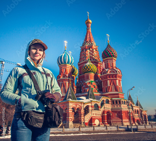 Photography Happy young woman standing against to Saint Basil's Cathedral on Red Square in Moscow, Russia