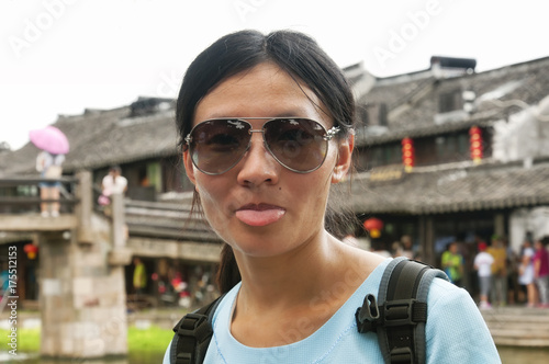 Chinese woman sticking out her tongue
