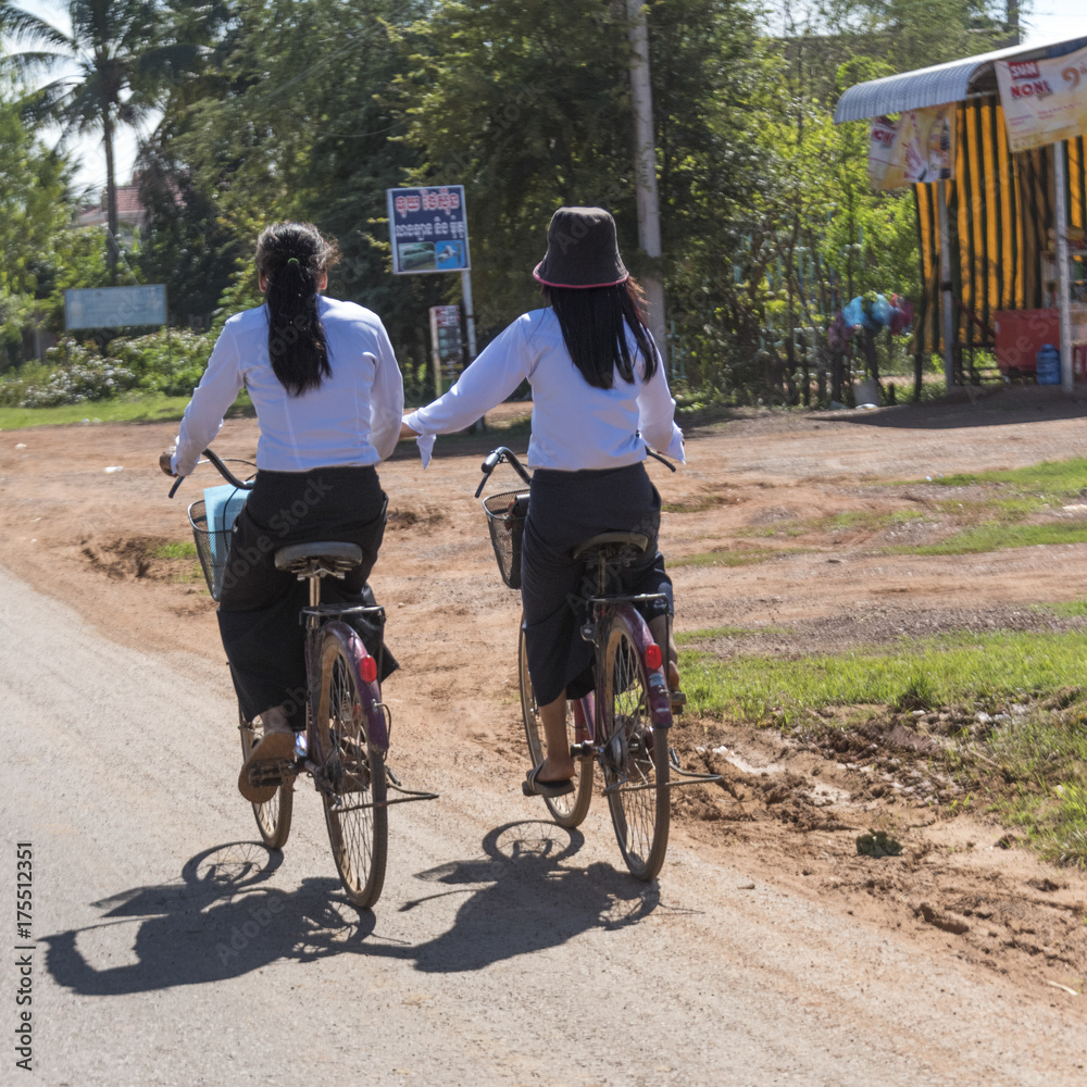Rear view of two women riding bicycles, Damdek, Siem Reap, Cambodia
