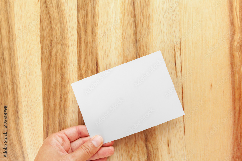 Blank paper on wood table Blank paper on wood table