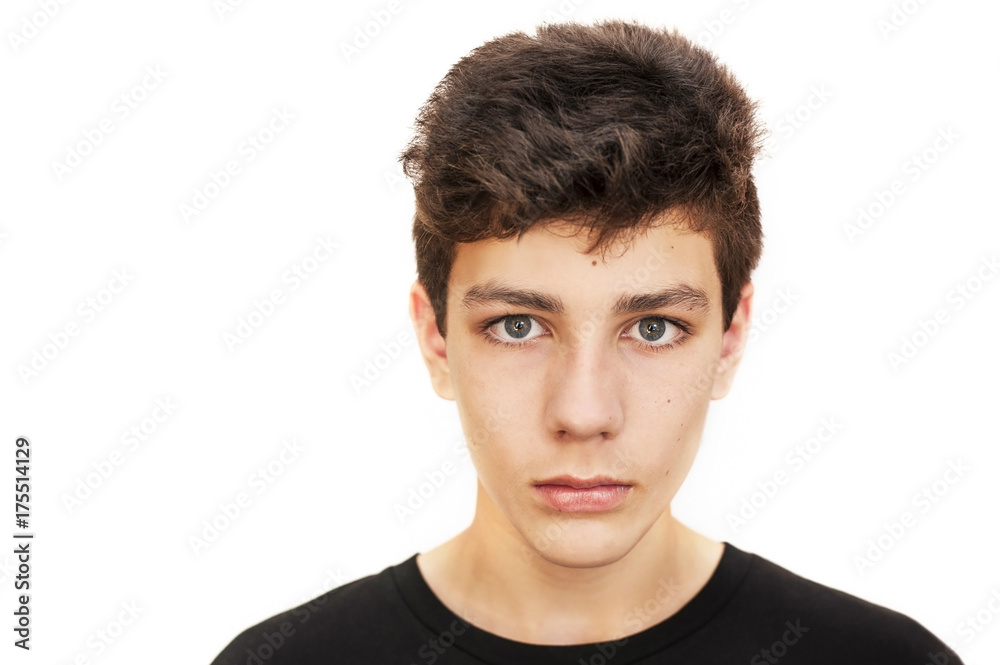 A beautiful boy with dark hair and a serious face on a white background  Stock Photo | Adobe Stock