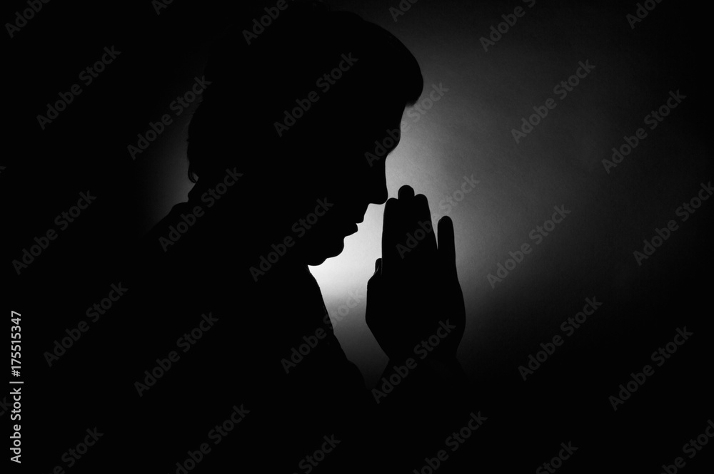 Praying silhouette man