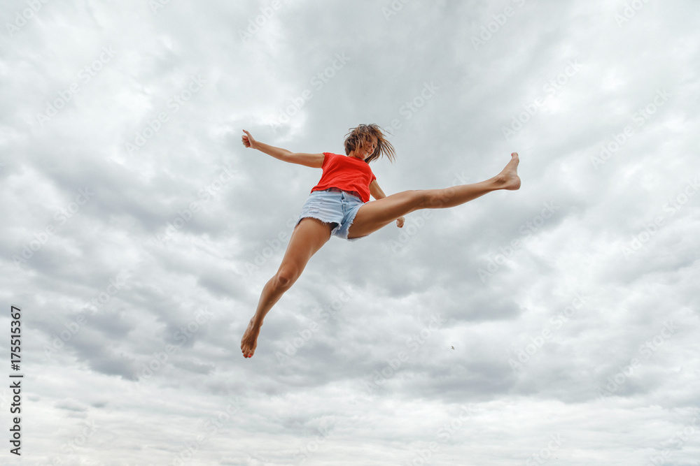 The young girl jumps with joy. A good extension, a twine in air The young girl jumps with joy. A good extension, a twine in air