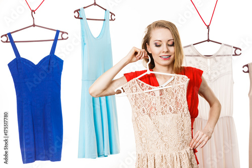 Woman in shop or wardrobe picking dress