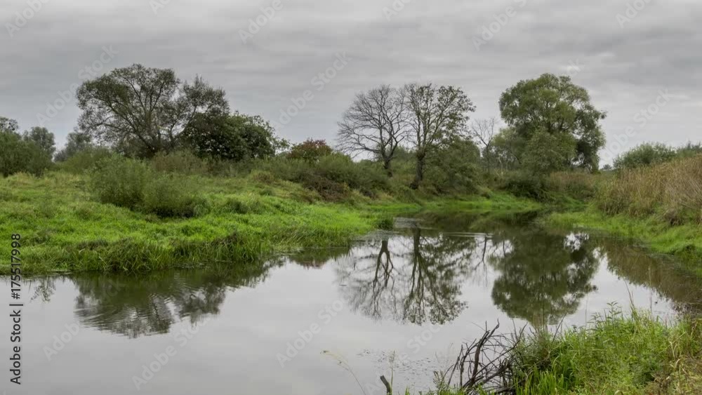 Autumn river landscape, time-lapse 4K. Low clouds reflected in the water. River Pripyat, Belarus.
Autumn river landscape, time-lapse 4K. Low clouds reflected in the water. River Pripyat, Belarus.