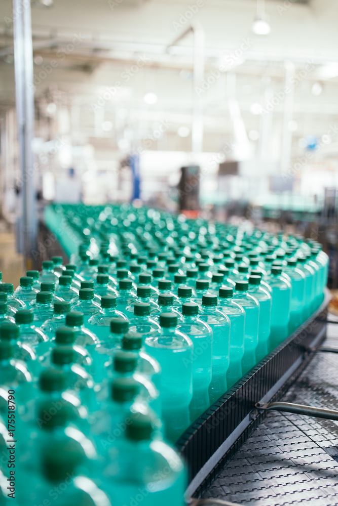 Fototapeta premium Bottling plant - Water bottling line for processing and bottling pure mineral carbonated water into bottles.