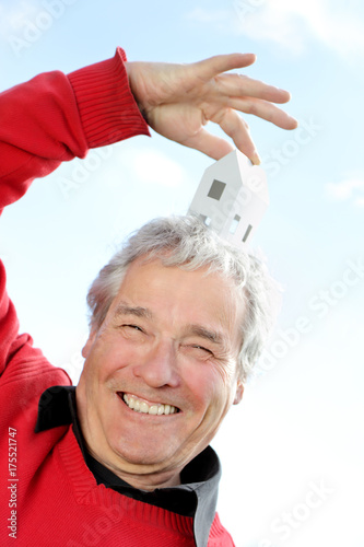 Series of a happy Senior Pensioner, imagining his new future home with a Little Paper house photo