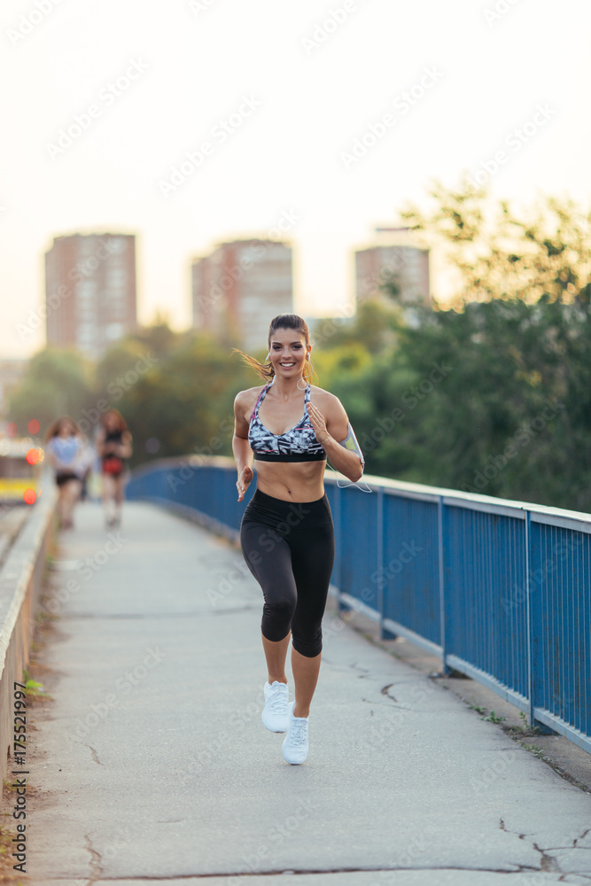 Beautiful athletic woman running outdoors