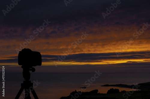 Camera on tripod with ocean and sunset in background   St Ives   Cornwall   United Kingdom