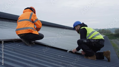  Technicians checking the panels at solar energy installation photo