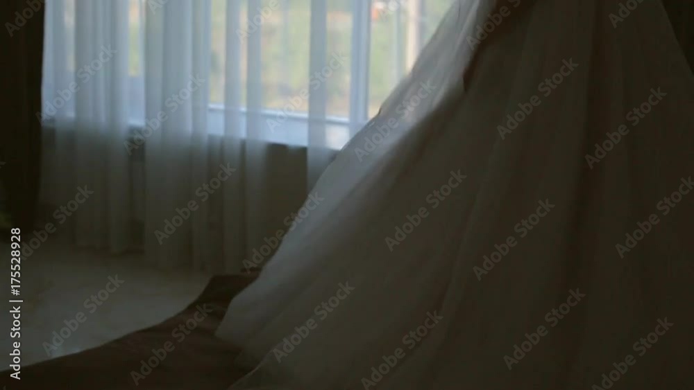 cheerful and beautiful bride jumping on bed in hotel room on wedding day cheerful and beautiful bride jumping on bed in hotel room on wedding day