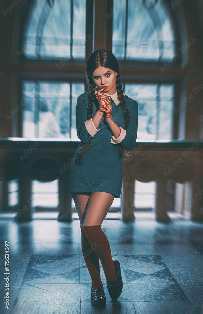 Angry girl student after the exam with bloody hands. Gothic look for a  Halloween party.Creative colors.The background of the old castle window  Photos | Adobe Stock
