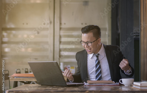 Happy business man celebrating success at company