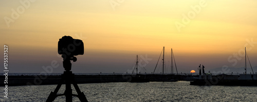 Camera on tripod with sea and sunset in background / Gouves, Crete, Greece  © Marcin