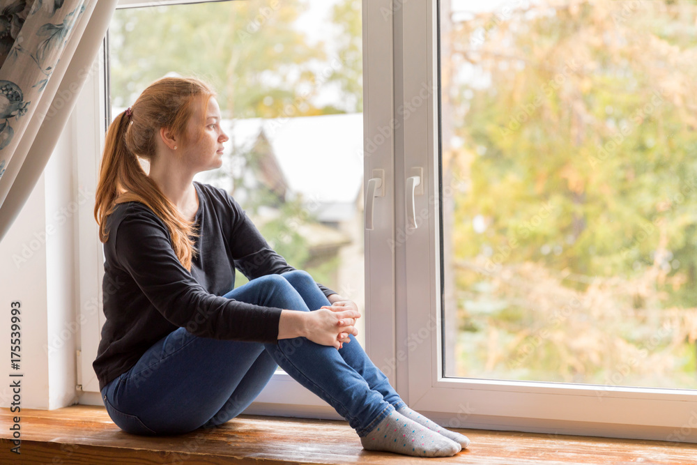 Girl sitting at the window Girl sitting at the window