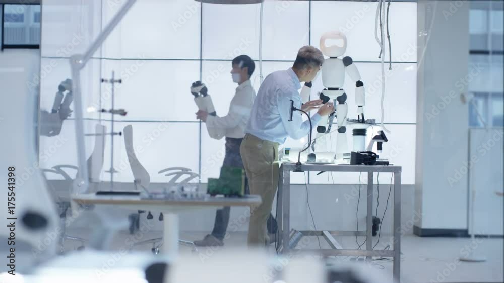Technical engineer working on construction of automated robot in modern lab Technical engineer working on construction of automated robot in modern lab