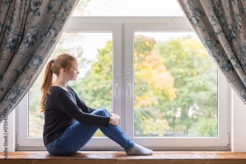 Girl sitting at the window. Motivation, loneliness, self-development Free Download Girl sitting at the window. Motivation, loneliness, self-development - GFXLoad
