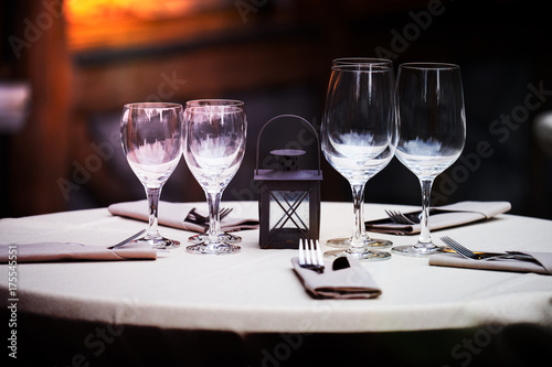 Elegant restaurant decoration with wine glasses and tables from the barrel