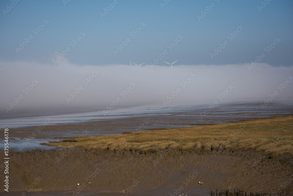 wind turbines engulfed in fog bank wind turbines engulfed in fog bank