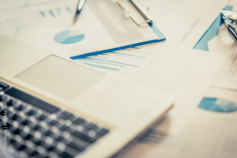 Many charts and graphs with pen-pencil. Reflection light and flare. Concept image of data gathering and statistical working. Many charts and graphs with pen-pencil. Reflection light and flare. Concept image of data gathering and statistical working.