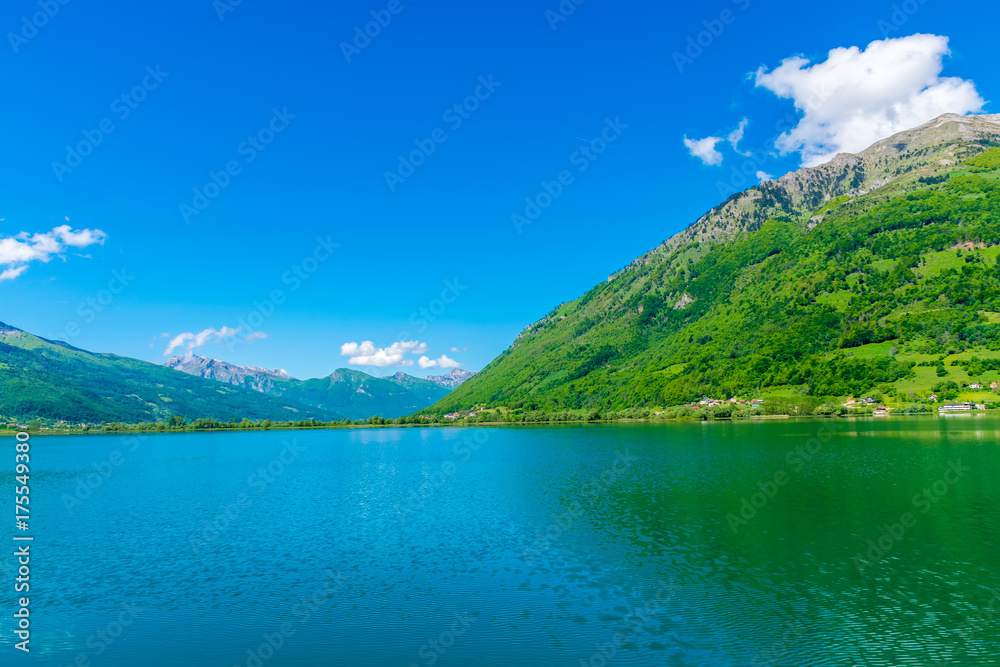 A picturesque mountain lake is located in a valley among the mountains.