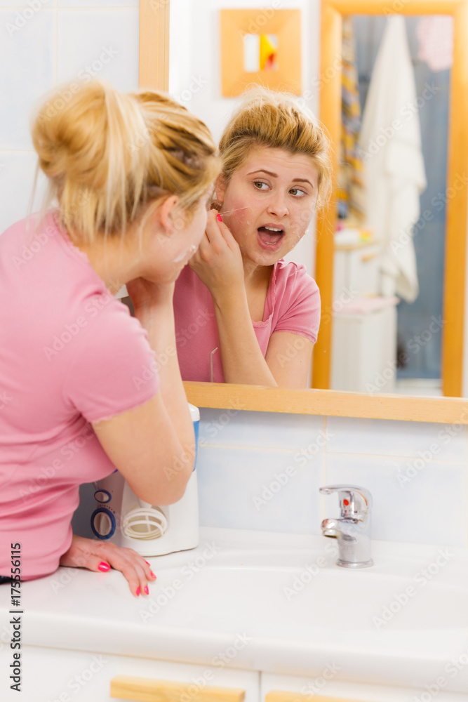 woman removing peel off mask from her face woman removing peel off mask from her face