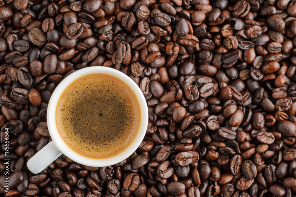 cup of coffee espresso on coffee beans background. top view cup of coffee espresso on coffee beans background. top view