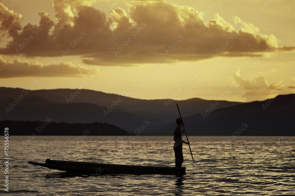 Man Paddling a Canoe