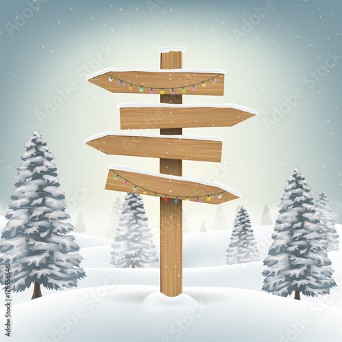 christmas wood direction board sign in snow forest