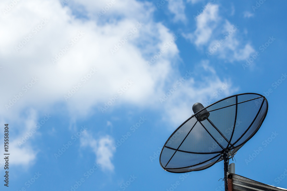 Satellite dish cable on roof with blue sky and some cloud.